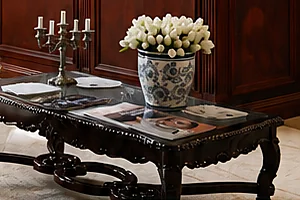 Antique table with tulips and reading material in the lounge