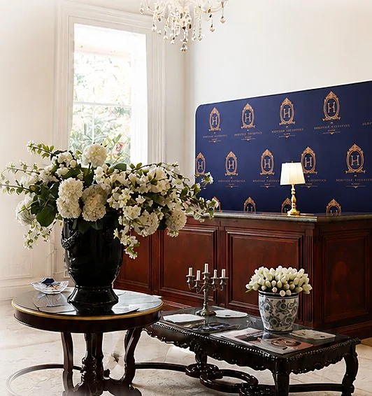 Reception with signature Heritage navy backdrop and fresh flowers